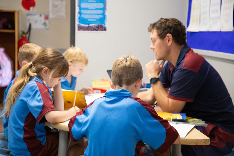 A teacher working with a small group of students.